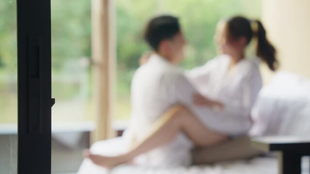 Blurred asia people young adult body on hotel cozy sofa bed outdoor home in health care safe sex flirt relax hug kiss. I love you man woman falling in love tender sexual pose happy asian just married.