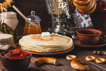 Tea party with pancakes, samovar tea and pickles