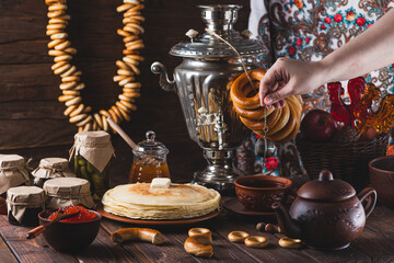 Tea party with pancakes, samovar tea and pickles