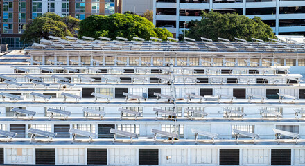 White Urban Roof with an Array of  Solar Panels.