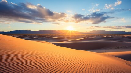 Fototapeta na wymiar Golden sunset over desert with cloud-streaked sky