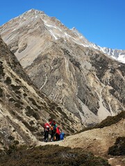 A group of adventurous people walking on top of a mountain