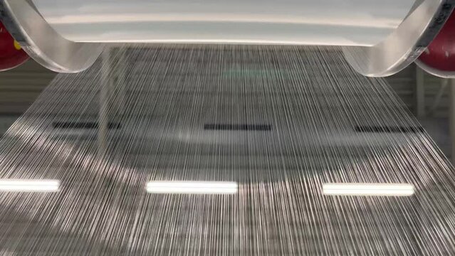 The unwinding of the threads from the bobbin of the warp of the knitting machine