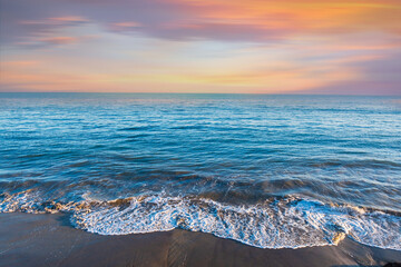 A Colorful Ocean Sunset Sky as a Gentle Wave Rolls in Santa Barbara Harbor Marina Ships Bay...