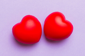 red heart shape on colored background. minimal concept top view with copy space