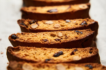 Rows of Almond and Cranberry Biscotti Cooling on Parchment, Intimate Kitchen Atmosphere