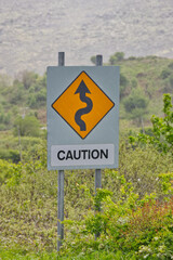 Road sign "Caution" because of a double curve