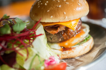 Viw of a hamburger with vegetables on the pate