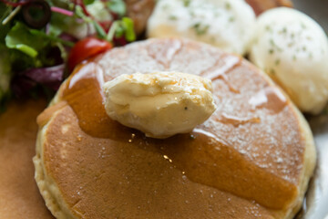 View of pancakes, sausages and vegetables on the plate in the restaurant
