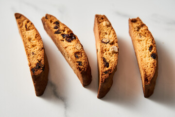 Four Almond and Cranberry Biscotti Standing on Edge, Marble Countertop with Soft Shadow Detail