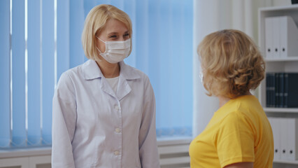A doctor and patient smile, satisfied with good work, celebrating recovery and teamwork