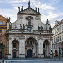 Fototapeta na wymiar Beautiful facade of the Saint Nicholas Church in Prague at the sunrise