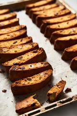 Rows of Almond and Cranberry Biscotti Cooling on Parchment, Intimate Kitchen Atmosphere