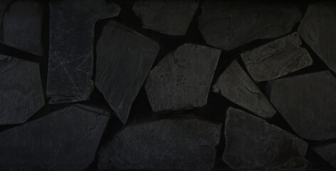 Black stone background. Dark rock wall texture. Abstract pattern. Natural backdrop. Decoration...