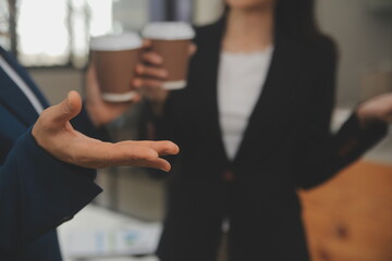 Entrepreneur Asian businessman and businesswoman discussing new business project in tablet in modern Meeting In Modern Office, Asian business casual concept.