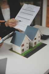 Business Signing a Contract Buy - sell house, insurance agent analyzing about home investment loan Real Estate concept.