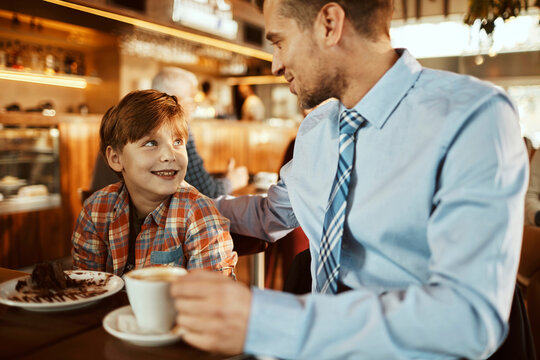 Father and son sitting in cafe - Powered by Adobe