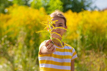 A child is allergic to ragweed blooming in the park. Selective focus.
