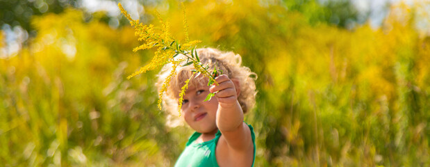 A child is allergic to ragweed blooming in the park. Selective focus. © yanadjan