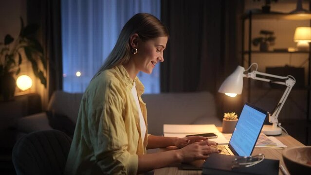 Beautiful blonde female freelancer working on a project late at night