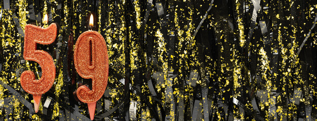 Burning red birthday candles on glitter tinsel background, number 59. Banner.