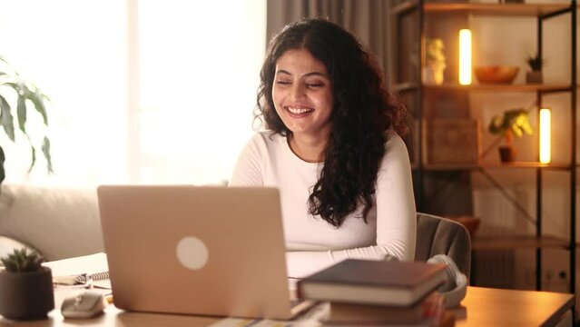 Beautiful young woman having video call conference meeting interview by laptop computer at home Confident female talking on working conversation having distance remote job indoors