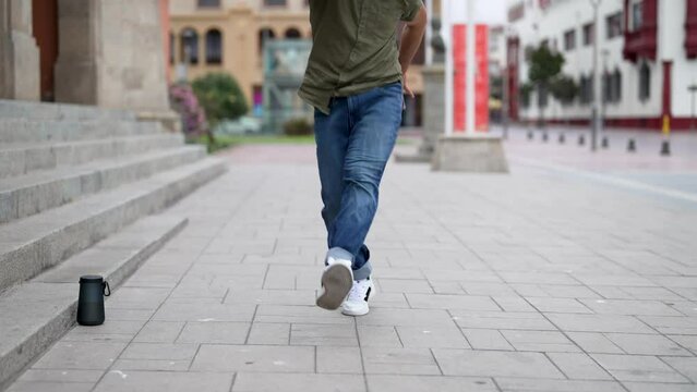 latin American breakdancer performing foot movements or toprock on the street