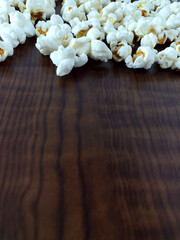 Popcorn spread on wooden table with copy space