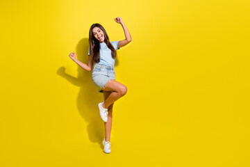 Photo of positive cheerful teen girl enjoy winning in competition isolated over vivid color background