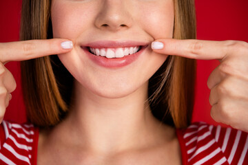 Cropped photo of funky toothy lady dressed striped top showing fingers white teeth smile isolated red color background