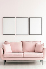 Frames mock up on color wall hanging above cozy home sofa. Modern living room comfortable stylish trendy couch posters decor background. Empty blank pictures canvas interior design decoration mockup .