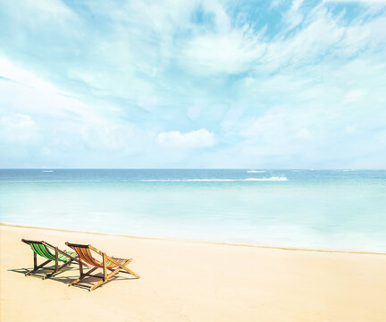 Lounge chairs on a tropical beach at summer