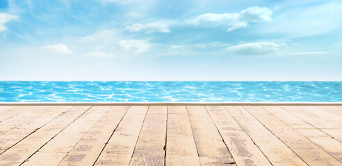 Wooden pier, exotic sea and a blue sky. Beautiful summer background. Vacation and traveling.