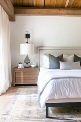 Cozy bedroom interior design. Modern light house or hotel room with comfortable large king size bed, luxury linen and stylish trendy minimal or classic decor background. Bedroom home furniture shop .