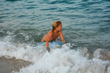 A boy plays in the sea waves