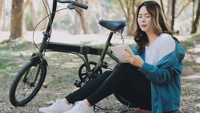 Happy Asian beautiful young woman riding bicycle on street outdoor near building city, Portrait of smiling female lifestyle using bike in summer travel means of transportation, ECO friendly