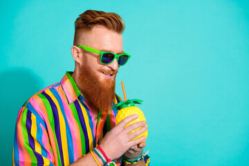Portrait of cool funky charismatic man macho in sunglass and striped shirt trying sweet cocktail...