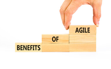 Benefits of agile symbol. Concept words Benefits of agile on beautiful wooden blocks. Beautiful white table white background. Businessman hand. Business benefits of agile concept. Copy space.