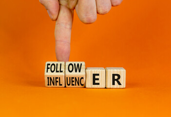 Follower or influencer symbol. Concept words Follower Influencer on wooden cubes. Beautiful orange...
