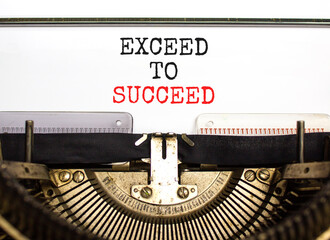 Exceed to succeed symbol. Concept words Exceed to succeed typed on beautiful old retro typewriter. Beautiful white paper background. Business and exceed to succeed concept. Copy space.