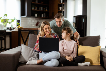 Family Bonding Time With Laptop in Cozy Home Setting