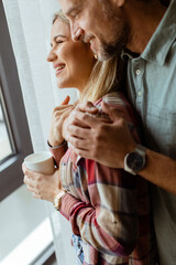 Tender Embrace by the Window: Couple Sharing a Serene Moment Indoors