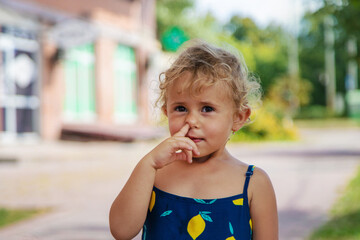 The child picks his nose. Selective focus.