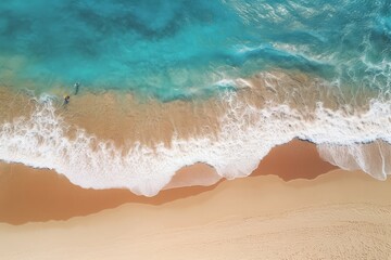 Fototapeta na wymiar Aerial view of beach waves crashing onto the sandy shore with a person walking.