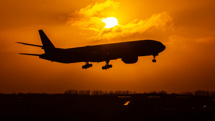 Fototapeta na wymiar airplane in the sunrise, sunrise at the airport