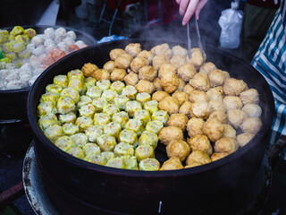 Handmade Colorful Dim Sum with different fillings. Steamed dumplings in many flavors, delicious Malaysia Chinese street food.