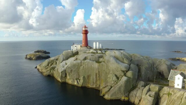 Svenner Lighthouse on Norwegian coast Island, drone footage pulls back revealing the lighthouse keepers village