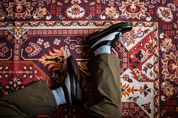 Close-up view of two-tone wingtip brogue shoes made of genuine leather worn indoors on the classic...