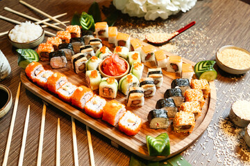 Wooden Platter Filled With Sushi and Chopsticks