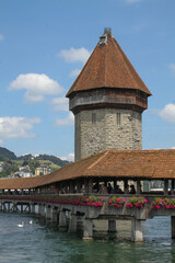 Photo of castle bridge and tower over the Reuss River in Lucerne Switzerland accented with white...